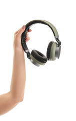 Hand with modern headphones on white background