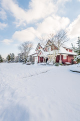 A perfect neighbourhood. Houses in suburb at Winter in the north America. Luxury houses covered nice snow.