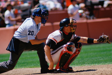 Baseball catcher and umpire at game