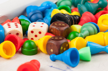 Colorful figures and dices of ludo family board game.