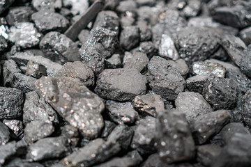 Char-coal. Pattern, heap. Pile of Bituminous Coal cinder. Stone coal Industry, business. Black coal mine close-up with soft focus. Anthracite coal bar