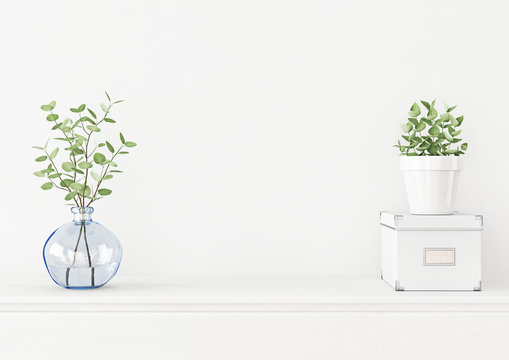 Interior wall mockup with branches in blue vase, box and green plant in pot on empty white background. 3D rendering, illustration.