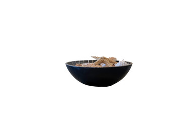 Wooden bowl with starfish on top of shells.