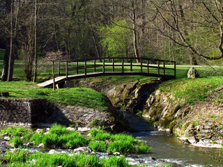 Fototapeta na wymiar Wooden bridge on river Blanice, public park in city Vlasim, central bohemia region, Czech republic