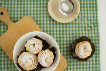 Cruffins without filling on a green background. Rustic style.