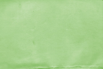 Cardboard green abstract pattern texture close-up. Retro old paper background. Grunge concrete wall. Vintage blank wallpaper.