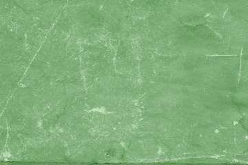 Cardboard green abstract pattern texture close-up. Retro old paper background. Grunge concrete wall. Vintage blank wallpaper.