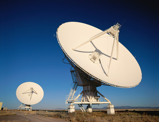 Two VLA Very Large Array radio telescope dishes facing up