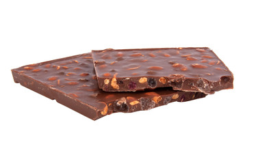 milk chocolate with nuts and berries brocken isolated on the white