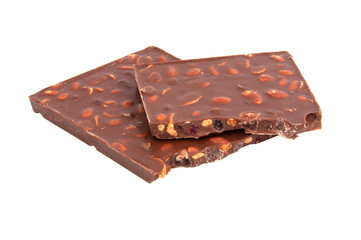 milk chocolate with nuts and berries brocken isolated on the white