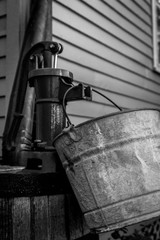 Fototapeta na wymiar Antique Water Faucet With Bucket