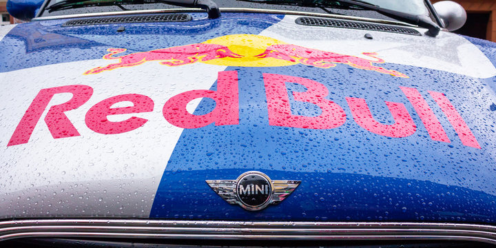 Uzhhorod, ukraine - 14 JUL, 2013: Red Bull mini cooper publicity car detail. fancy car tuning used for promotion. wet advertisement vehicle after the rain