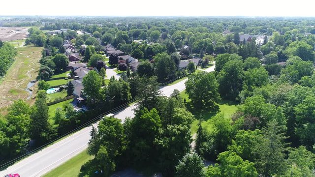 Aerial Over Forests Towards Modern Neighborhood Green Trees Houses