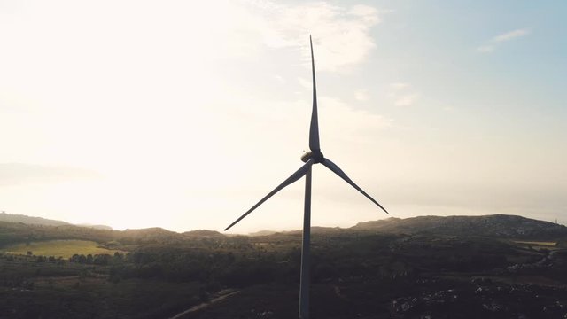 Viewpoint with a wind turbine, overlooking mountains and seacoast. Aerial parallax shot with copy space. playa barizo, Malpica, Spain