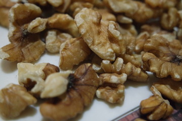 Close-up top view of peeled walnut on a white background