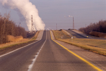 Highway with industrial cloud in background