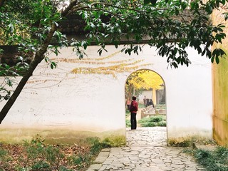 Obraz na płótnie Canvas Woman standing behind the Chinese arch 