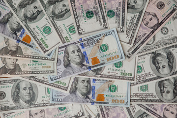 background from scattered dollar banknotes as abstract seamless. toned image