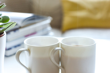Relaxing sofa area with coffee table and hot drink in modern home interior