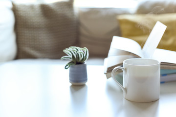 Relaxing sofa area with coffee table and hot drink in modern home interior