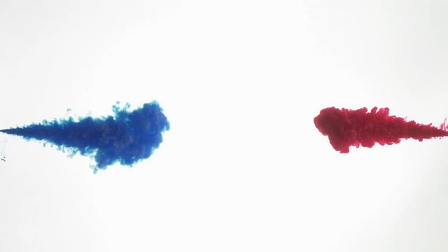 Blue and red ink being poured into water, Slow motion