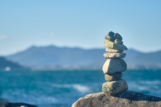 Selective Focus Shot Of Rocks Stacked Upon Each Other At The Beach