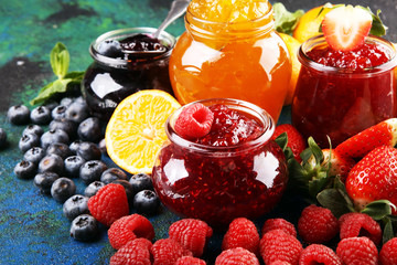 assortment of jams, seasonal berries jelly, mint and fruits and tangerine