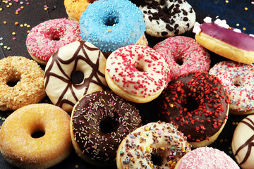 assorted donuts with chocolate frosted, pink glazed and sprinkles donuts - 316892070