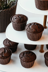 Cooking chocolate cream cupcakes. Confectioner cooks in kitchen.