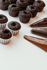 Cooking chocolate cream cupcakes. Confectioner cooks in kitchen.