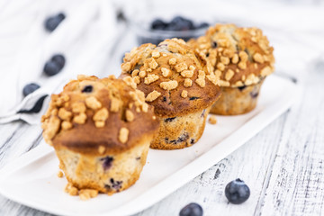 Some Blueberry Muffins (close-up shot; selective focus)