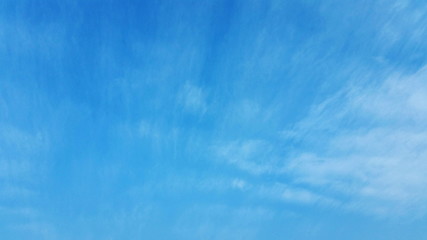 A Blue Sky Abstract. A blue sky with just a wisp of cloud to use being a backing or backdrop royalty free stock photo.