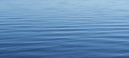Calm surface of light blue water as a background