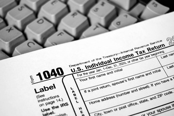 close up of Internal Revenue Service 1040 income tax form on computer keyboard