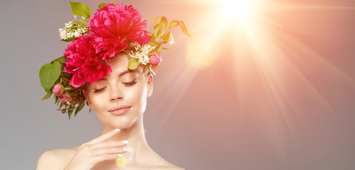 Beauty woman with flowers on head. Happy beautiful girl on gray banner background. Pretty model...