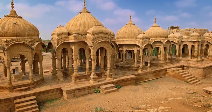 Bada bagh cenotaphs (Hindu tomb mausoleum) made of sandstone in Indian Thar desert. Jaisalmer, Rajasthan, India. Horizontal panning