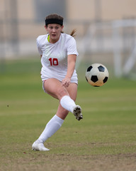 Young athletic girl playing in a soccer match