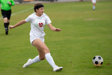 Young athletic girl playing in a soccer match