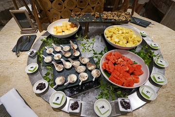 Buffet bar station of assorted fruits and desserts- watermelon, pineapple, cantaloupe, chocolate fudge brownie, Tiramisu and Thai style cake