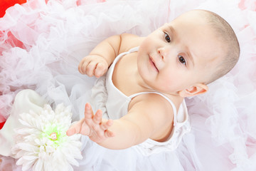 Angel baby from heaven in white dress at the big red heart. Studio. Happy Valentines Day.
