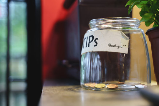 Glass Tips Jar In Cafe