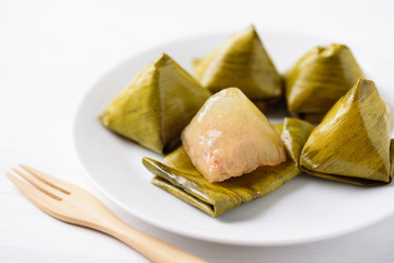Thai dessert (Khanom Tian), sweet stuffed dough pyramid wrapped by banana leaf