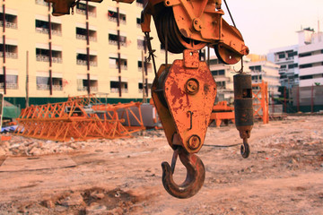close up hook and crane in working site,project building hospital construction for health services in urban with cranes and worker,front view building with decoration