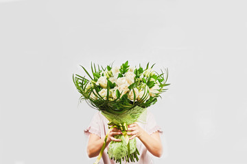 Young pretty woman hold luxurious bouquet.