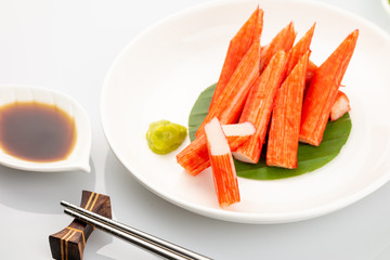 Imitation Crab Stick on a plate on white background, Japanese food