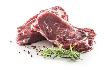 Beef Rib Eye steak with pepper and rosemary isolated on white background