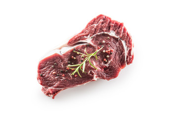 Beef Rib Eye steak with pepper and rosemary isolated on white background