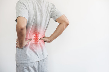 Office syndrome, Backache and Lower Back Pain Concept. a man touching his lower back at pain point - 316912699