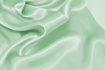 Draped satin green fabric for festive backgrounds