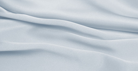 Fototapeta premium Draped satin blue fabric for festive backgrounds